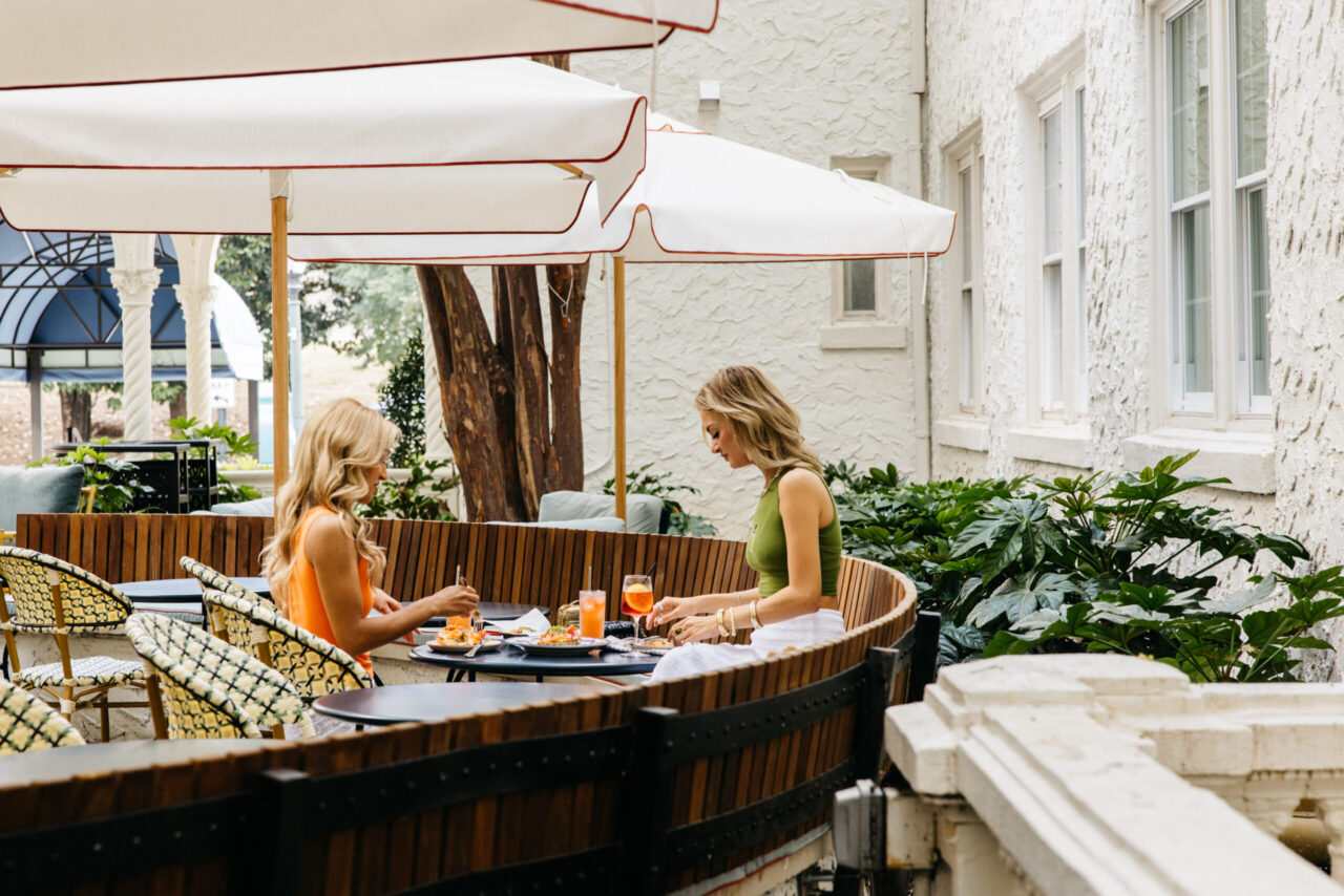 Two women enjoying their meal at Pom Court