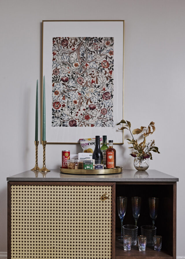 Picture frame above a cocktail cabinet