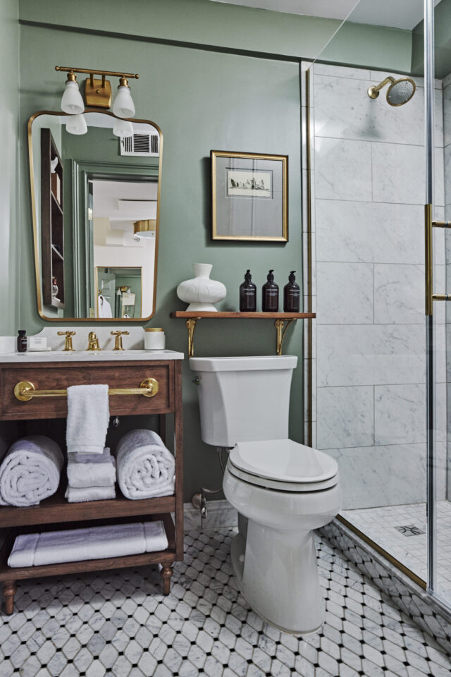 Bathroom with toilet, towels and mirror