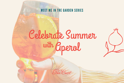 Promotional banner showing a hand holding an Aperol Spritz with an orange slice; text reads 'Celebrate Summer with Aperol' in front of a garden-themed illustration.